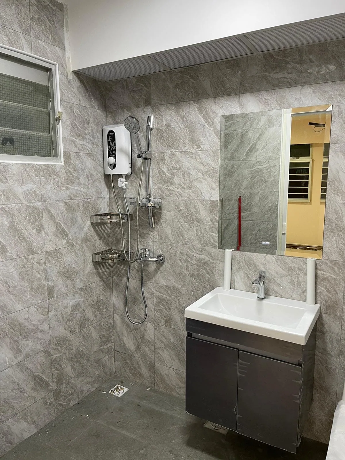 Jurong HDB bathroom with grey stone-look tiles, dark vanity and white basin
