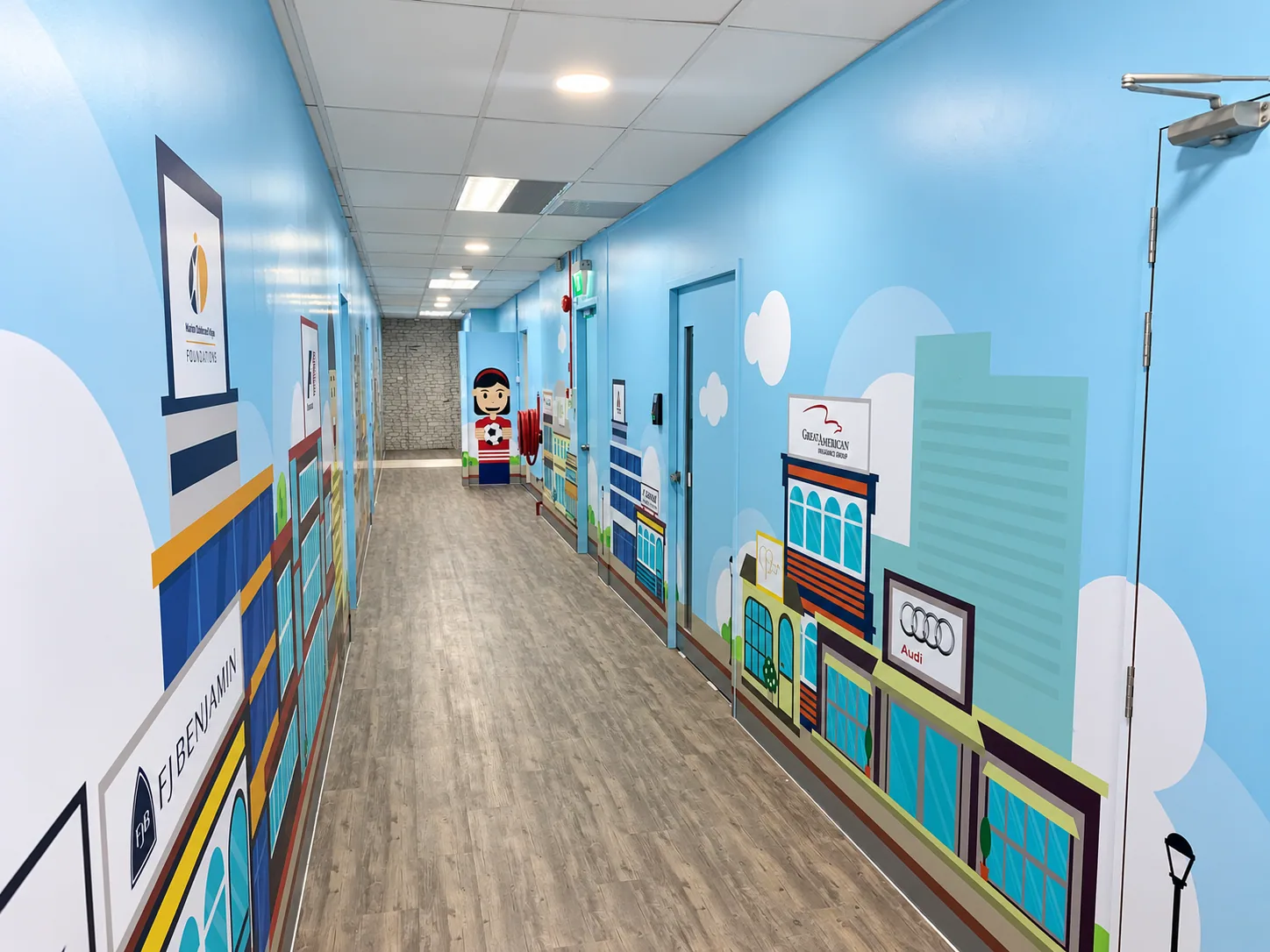 Office corridor lined with blue illustrated wall graphics