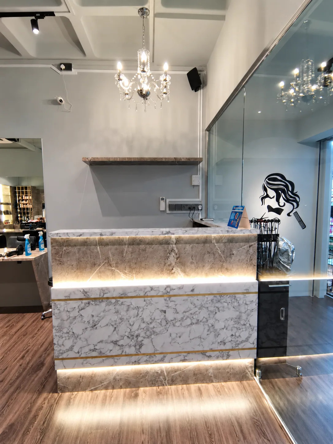 Bukit Batok salon reception with marble-look finishes and integrated lighting