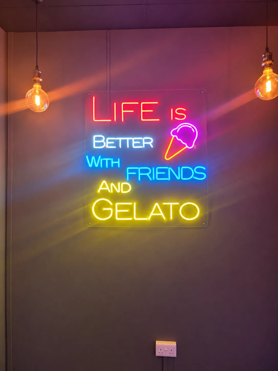 Decorative neon quote and ice cream illustration inside the Tampines shop