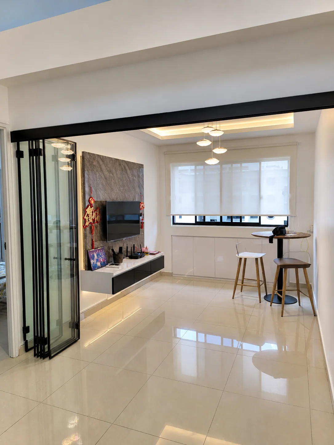 Toh Guan living room with floating console, feature wall and warm ceiling lighting